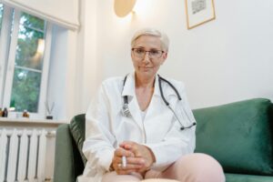 An image of a compassionate healthcare provider engaged in a virtual consultation with a patient. The provider, seen on the screen of a laptop, listens attentively to the patient's concerns. The patient, visible on the screen as well, appears comforted by the provider's empathy and understanding.